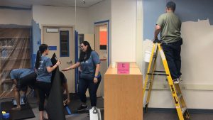 Volunteers lend a hand to help beautify a CCSD school library